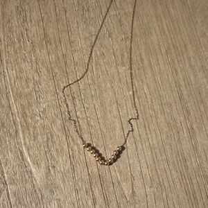 E Newton gold ball necklace